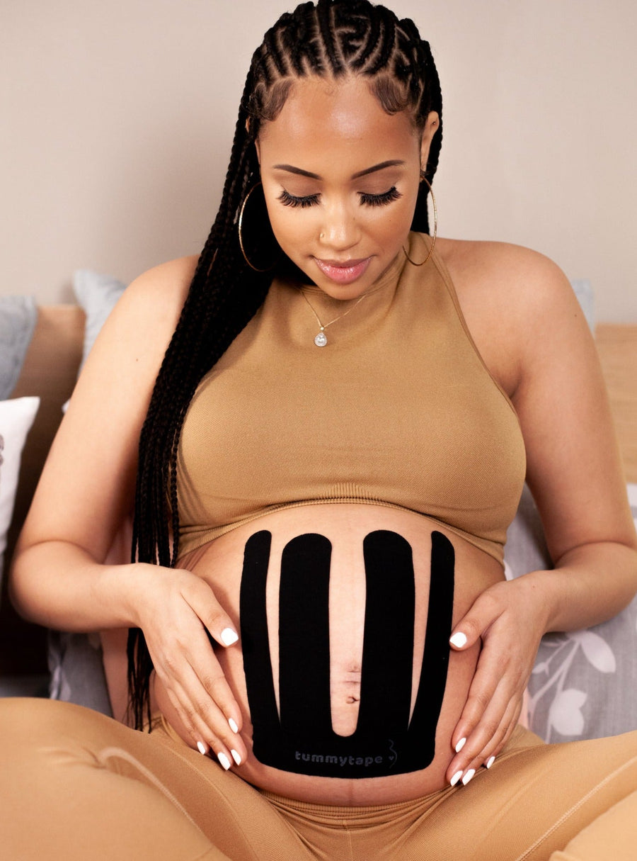 pregnant woman wearing black pregnancy tape. Caption reads "For sensitive skin"